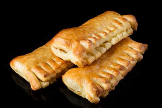Bun with a puff pastry on a dark background