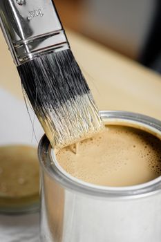 closeup the man hand using paintbrush to painting the wood plank