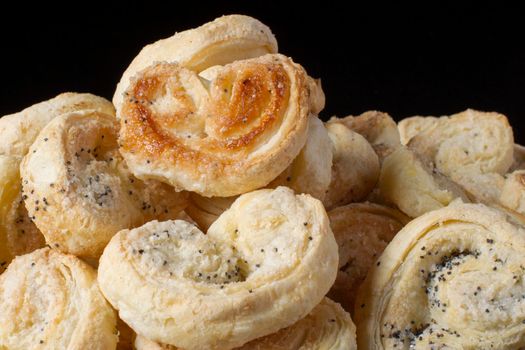 Cookies puff pastry ears on a dark background