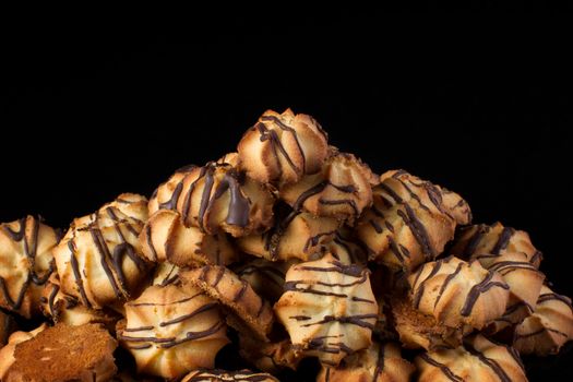 Shortbread cookie with chocolate icing on a dark background