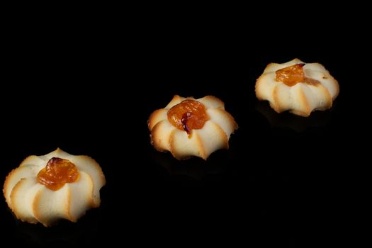 Shortbread cookie with jam on a dark background