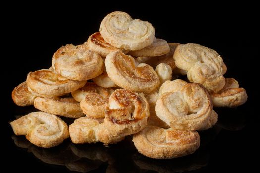 Cookies puff pastry ears on a dark background
