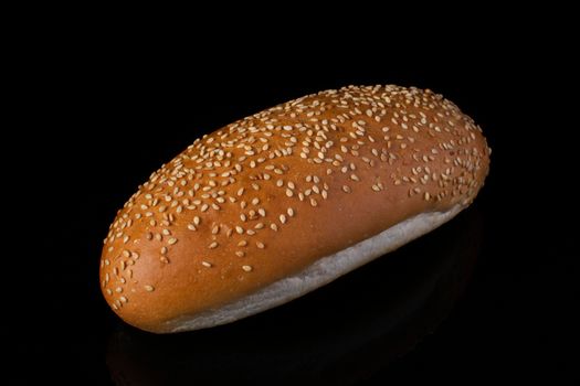 Buns with sesame for hotdog on a dark background.Loaf