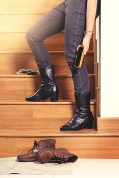 young woman wearing black leather boots after polishing. Fashion black leather boots with zip.