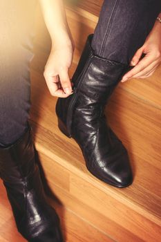 young woman wearing black leather boots, Fashion black leather boots with zip.