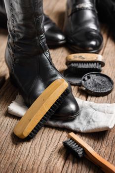 black leather boots with shoe maintenance set