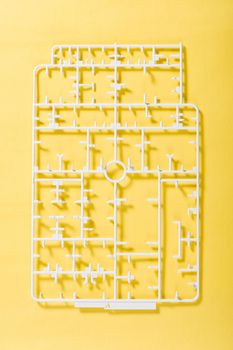 sprue or injection moulding of model on yellow background