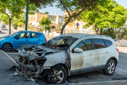 Burned car close up. Car after the fire, crime of vandalism, riots. Arson car. Accident on the road due to speeding. Explosion. High quality photo