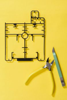 sprue or injection moulding of model on yellow background