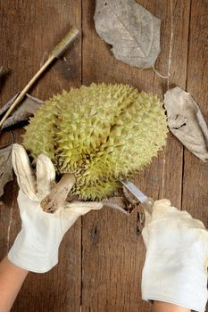 peeling Thai durian on wooden table
