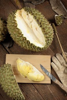 peeling Thai durian on wooden table