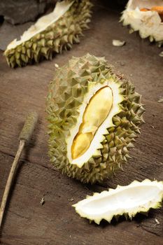 peeling Thai durian on wooden table