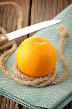 Ripe orange on wooden table