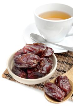 closeup sweet dried dates fruit with tea