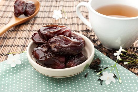 closeup sweet dried dates fruit with tea