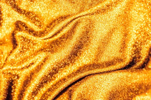 Luxe glowing texture, night club branding and New Years party concept - Golden holiday sparkling glitter abstract background, luxury shiny fabric material for glamour design and festive invitation