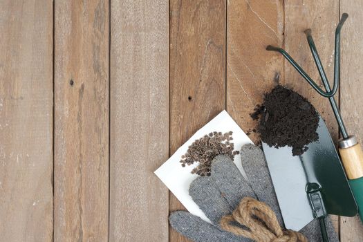 gardening tools on wooden plank background