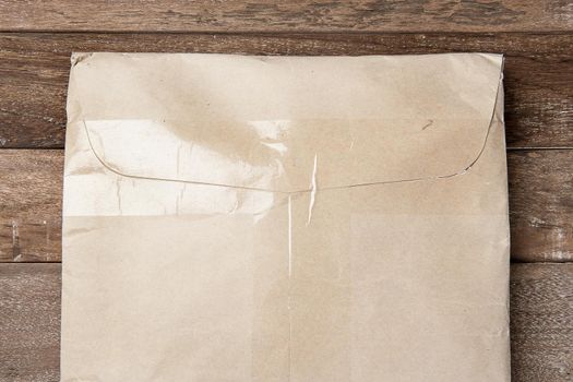 closeup brown envelope on wooden plank