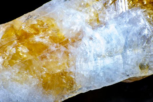 macro shooting of natural rock specimen. Raw crystal of Citrine yellow quartz gemstone from Brazil. Shimmering gold background. High quality photo