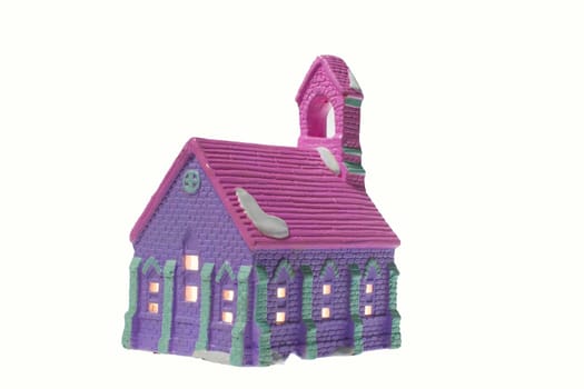 Children's small house on a white background.A gypsum product painted with acrylic paint in the form of a village house