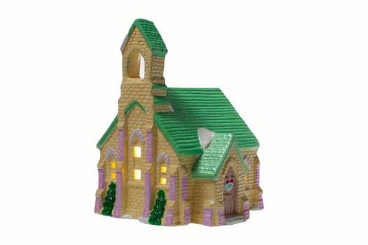 Children's small house on a white background.A gypsum product painted with acrylic paint in the form of a village house