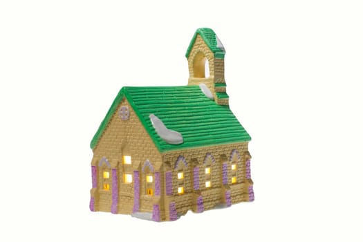Children's small house on a white background.A gypsum product painted with acrylic paint in the form of a village house