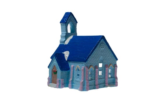 Children's small house on a white background.A gypsum product painted with acrylic paint in the form of a village house