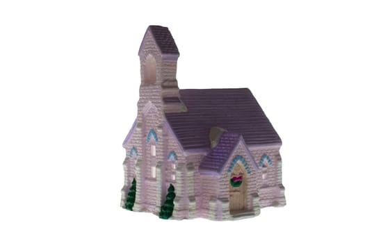 Children's small house on a white background.A gypsum product painted with acrylic paint in the form of a village house