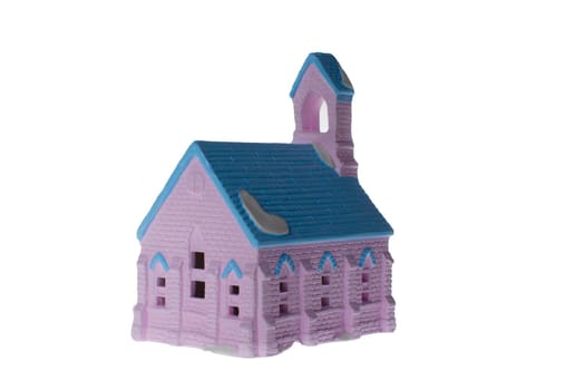 Children's small house on a white background.A gypsum product painted with acrylic paint in the form of a village house