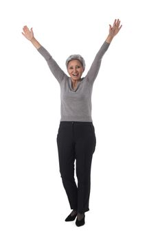 Mature asian business woman winner with raised arms isolated on white background full length studio portrait