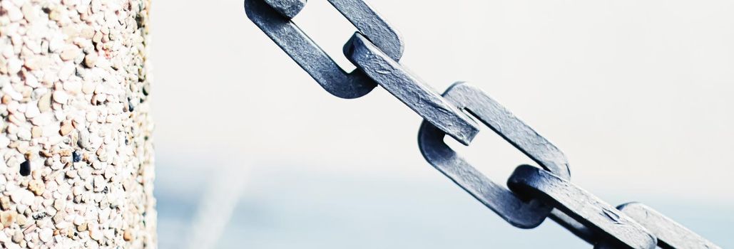 Metal chain closeup, marine background.