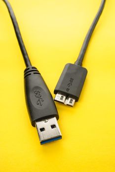 closeup detail of USB 3.0 connector on yellow paper