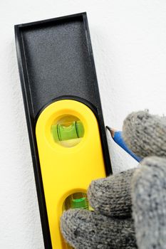 Technician using the spirit level to install furniture