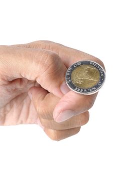 man ready to flip Thai 10 Baht coin on white background