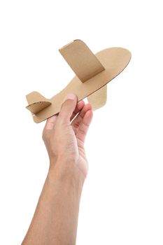 cardboard plane in the hand on white background