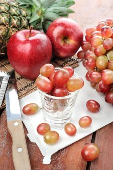 closeup fresh red grapes on wooden plank