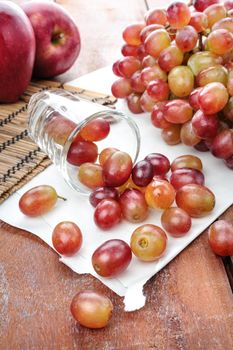 closeup fresh red grapes on wooden plank