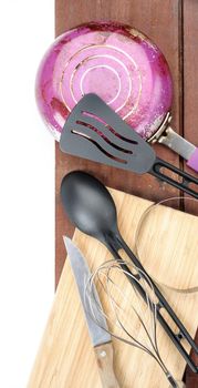 set of plastic spade of frying pan on wooden plank background