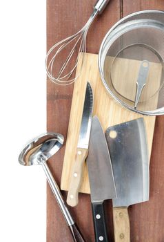 set of kitchenware on wooden plank background