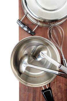 set of kitchenware on wooden plank background