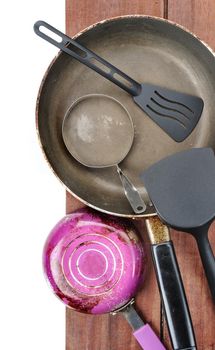 set of old frying pan on wooden plank background