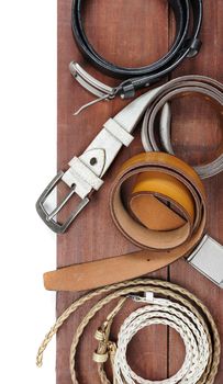 isolate leather belts on wooden plank