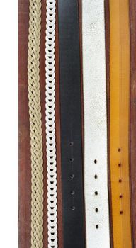 isolate leather belts on wooden plank