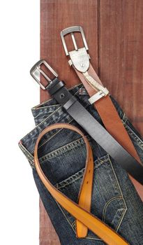 isolate leather belts on wooden plank