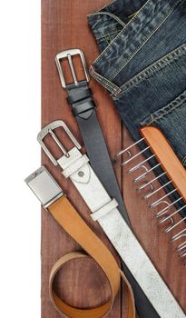 isolate leather belts on wooden plank