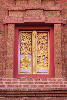 ancient golden carved shown biography of lord buddha on wooden window of Thai temple