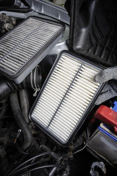 technician changing the air filter for car