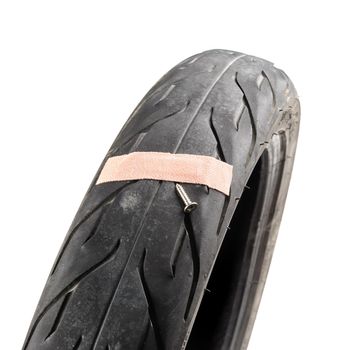 A damaged motorcycle tire first aid plaster. damaged motorbike tire