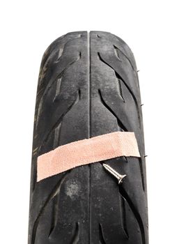 A damaged motorcycle tire first aid plaster. damaged motorbike tire
