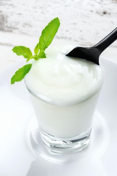 natural yogurt in glass on wooden plank, delicious natural yogurt 